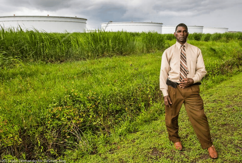 Pastor Harry Joseph near oil storage tanks in St. James, Louisiana, close to the Mount Triumph Baptist Church.