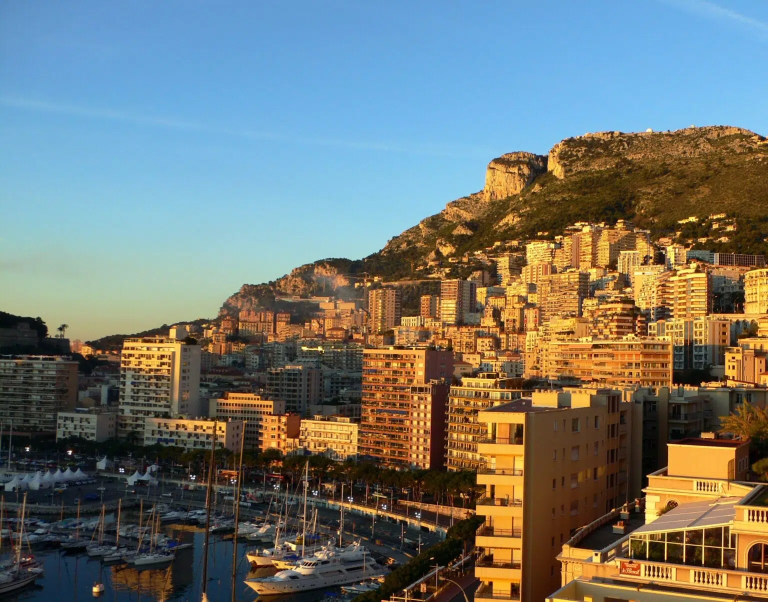 Sunset on yachts and high rise buildings on a bluff in Monte Carlo