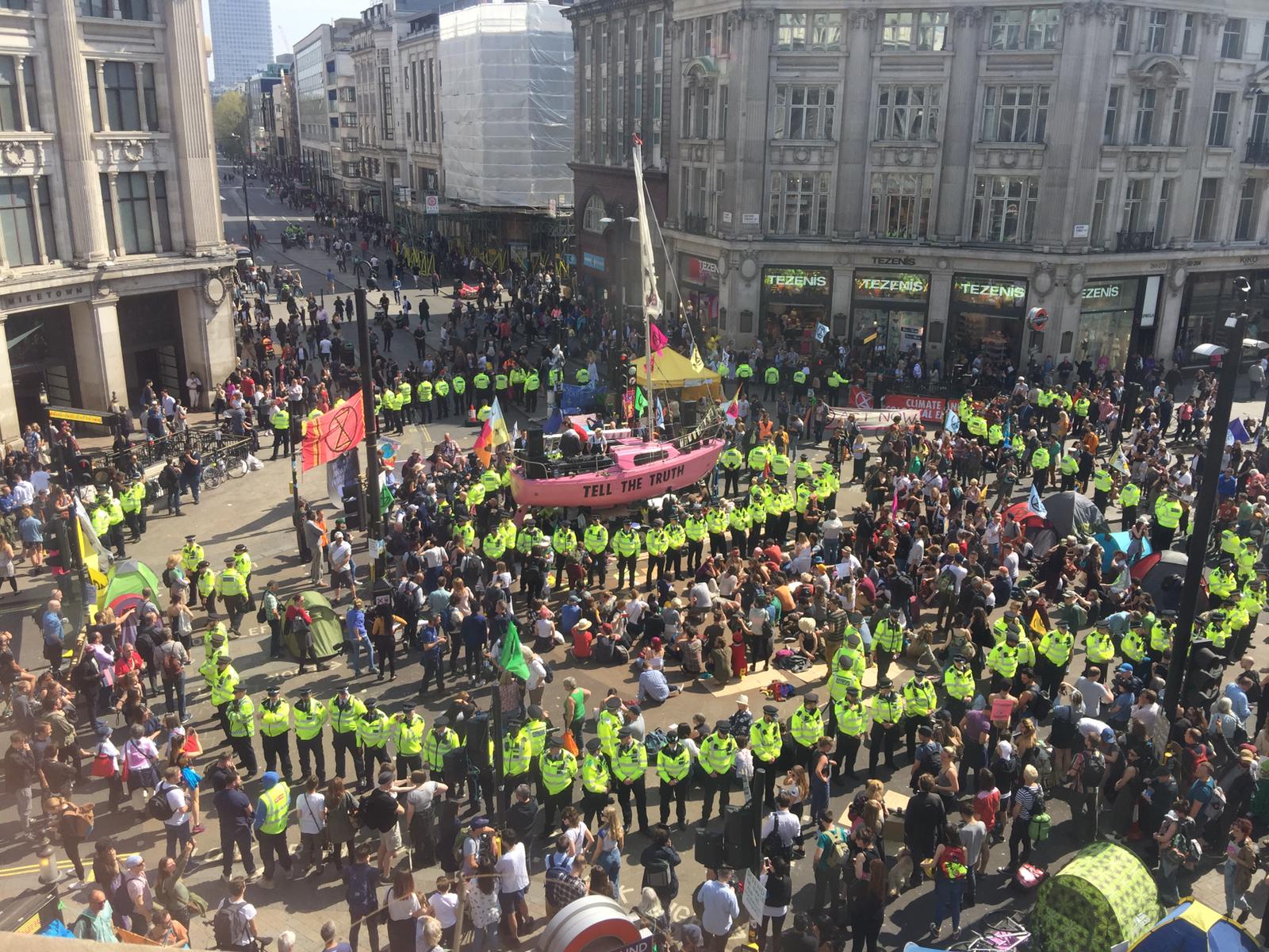 A group of Extinction Rebellion activists fill a public square in London, England