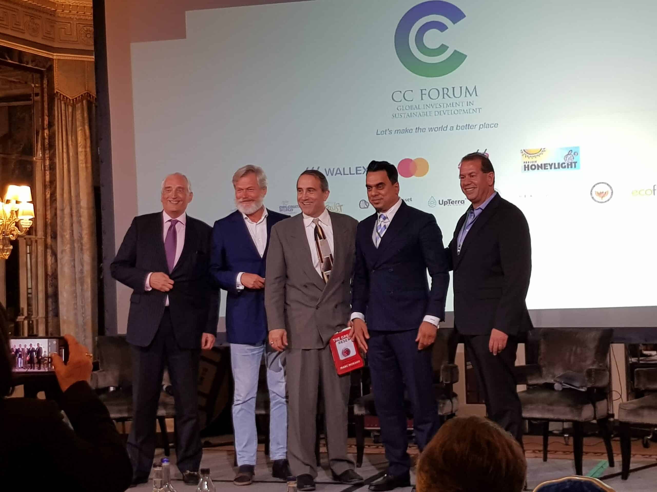 five white men in suits pose together at a conference