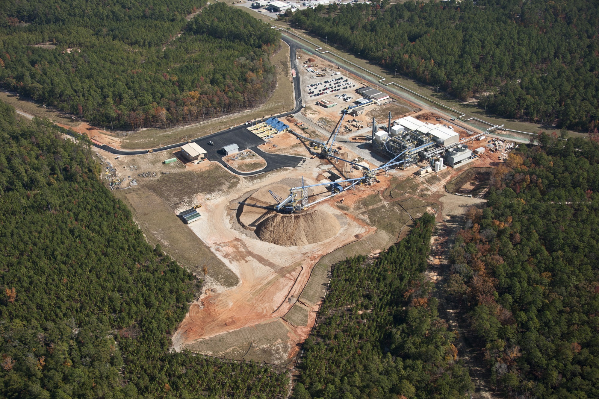 an aerial view of a biomass plant in the middle of a forest