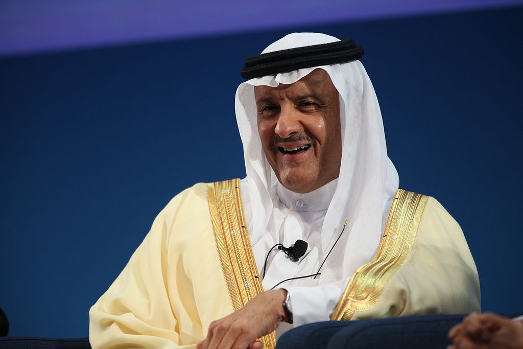 Photo of older man wearing yellow thwab, or Arabic robe, with white headdress