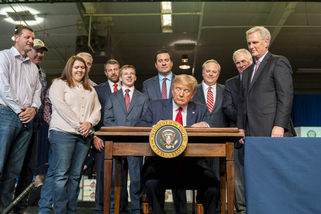 President Donald J. Trump, joined by U.S. Rep. Kevin McCarthy, R-Calif., Secretary of the Interior David Bernhardt, California representatives Devin Nunes and Tom Clintock, R-Calif., and Central Valley farmers, signs a U.S. Interior Department Record of Decision to improve California water accessibility for rural stakeholders February 19, 2020, in Bakersville, California.