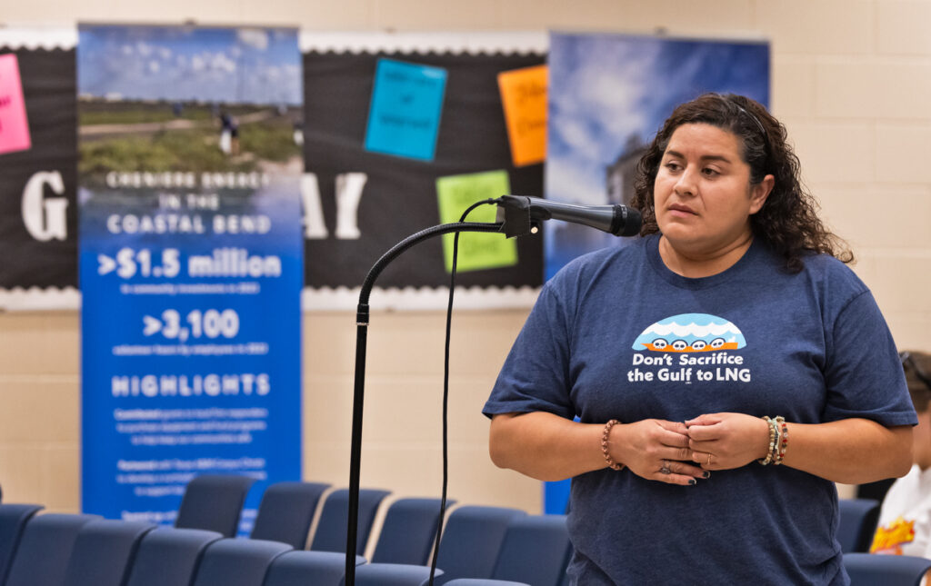 Elida Castillo testifying at a microphone at a public hearing about air quality permits for Corpus Christi LNG's expansion.