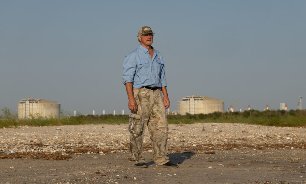 John Allaire walking across from Venture Global's LNG export terminal