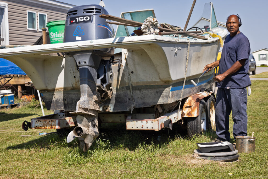 Solomon Williams working on his boat outside his home in Louisiana.