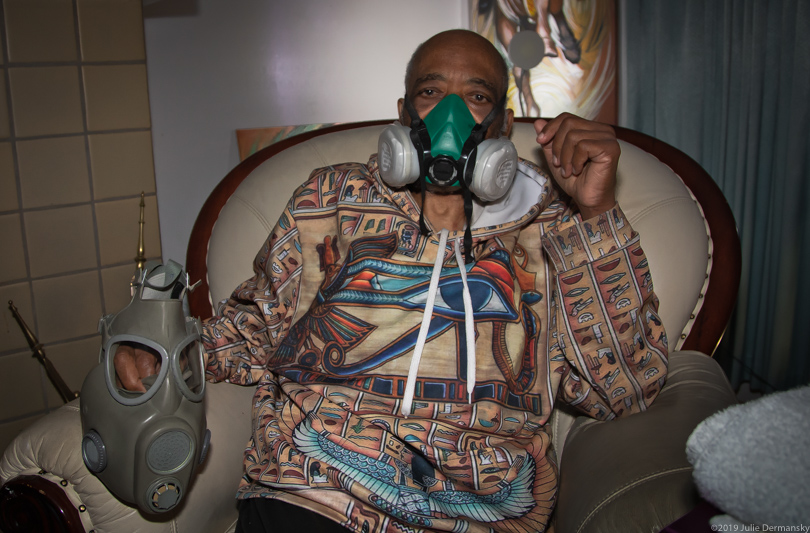 Johnie Perryman wearing a respirator in his home in Clairton